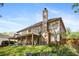 Backyard featuring a large back porch, a lush green lawn, and mature landscaping at 2898 Stockbridge Way, Dacula, GA 30019