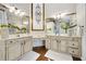 Bright bathroom with double vanities, white brick wall, and elegant decor at 2898 Stockbridge Way, Dacula, GA 30019