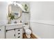 This half bathroom features a modern vanity, framed mirror, and stylish fixtures at 2898 Stockbridge Way, Dacula, GA 30019