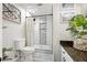Modern bathroom featuring tiled shower with built-in shelves, white vanity with granite countertop, and stylish fixtures at 2898 Stockbridge Way, Dacula, GA 30019