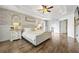 Well-lit bedroom features a tray ceiling, ceiling fan and luxury vinyl plank flooring at 2898 Stockbridge Way, Dacula, GA 30019