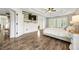 Well-lit main bedroom features a tray ceiling, ceiling fan and luxury vinyl plank flooring at 2898 Stockbridge Way, Dacula, GA 30019