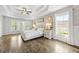 Well-lit bedroom with a tray ceiling, ceiling fan, luxury vinyl plank flooring, and bright, natural light at 2898 Stockbridge Way, Dacula, GA 30019