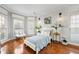 Cozy bedroom with hardwood floors, bay window, and white brick accent wall at 2898 Stockbridge Way, Dacula, GA 30019