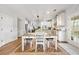 Bright dining area with a table, stylish chairs, and double doors to backyard at 2898 Stockbridge Way, Dacula, GA 30019