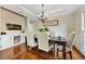 Cozy dining room with hardwood floors, a modern chandelier, and accent wood paneling at 2898 Stockbridge Way, Dacula, GA 30019