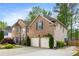 Brick house featuring a large garage, manicured lawn, and beautiful windows at 2898 Stockbridge Way, Dacula, GA 30019