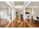 Bright foyer with hardwood floors, detailed trim, and a view into the living spaces at 2898 Stockbridge Way, Dacula, GA 30019