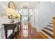 Bright foyer features hardwood floors, transom windows, and a decorative light fixture at 2898 Stockbridge Way, Dacula, GA 30019