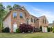 Charming brick house featuring a large garage, bench, manicured lawn, and beautiful windows at 2898 Stockbridge Way, Dacula, GA 30019