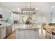 Spacious kitchen with white cabinets, granite countertops, an island, and stainless appliances at 2898 Stockbridge Way, Dacula, GA 30019