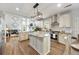 Spacious kitchen with white cabinets, granite countertops, an island, and stainless appliances at 2898 Stockbridge Way, Dacula, GA 30019