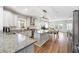 Spacious kitchen with white cabinets, granite countertops, an island, and stainless appliances at 2898 Stockbridge Way, Dacula, GA 30019