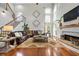 Spacious living room boasting soaring ceilings, large windows, a stone fireplace, and hardwood floors at 2898 Stockbridge Way, Dacula, GA 30019