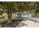 Charming single-story home with light gray siding, green lawn and long driveway at 5725 Brenda Sw Dr, Mableton, GA 30126