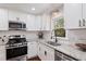 Well-appointed kitchen with stainless steel appliances, granite countertops, and white subway tile backsplash at 5725 Brenda Sw Dr, Mableton, GA 30126