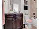 Full bathroom featuring a dark wood vanity, neutral tile, and a combination tub and shower at 15 Granville Ln, Covington, GA 30016
