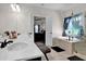 Bathroom with double sinks, white countertop, dark cabinetry, large mirror, tub and separate shower at 15 Granville Ln, Covington, GA 30016
