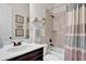 Bright bathroom with a combination tub and shower, a sleek vanity, and modern fixtures at 15 Granville Ln, Covington, GA 30016
