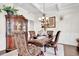 Formal dining room with an ornate china cabinet, decorative chandelier, and seating for four at 15 Granville Ln, Covington, GA 30016