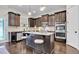 Spacious eat-in kitchen island with granite countertops, stainless appliances, and dark wood cabinets at 15 Granville Ln, Covington, GA 30016
