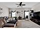 Inviting living room with comfortable seating, stylish decor, and a ceiling fan for added comfort at 15 Granville Ln, Covington, GA 30016