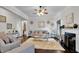 Spacious living room with hardwood flooring, fireplace, elegant decor, and natural lighting at 15 Granville Ln, Covington, GA 30016