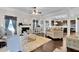 Open-concept living room with dark wood floors, plush rug, fireplace, and view into the kitchen at 15 Granville Ln, Covington, GA 30016