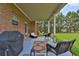 Relaxing covered patio with wicker furniture, and a view of the backyard at 15 Granville Ln, Covington, GA 30016