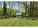 Backyard featuring a garden shed and manicured lawn at 259 Dartmoor Cir, Atlanta, GA 30328