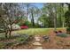 Landscaped backyard with garden, mature trees, and stone pathway at 259 Dartmoor Cir, Atlanta, GA 30328