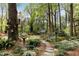 Lush backyard featuring a stone pathway, birdhouses and serene landscaping at 259 Dartmoor Cir, Atlanta, GA 30328