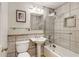 Well-lit bathroom featuring a shower over bath with glass screen, toilet, and vanity at 259 Dartmoor Cir, Atlanta, GA 30328