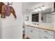 Bathroom featuring granite countertops, white cabinets, and a decorative mirror at 259 Dartmoor Cir, Atlanta, GA 30328