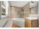 Tiled bathroom showcasing a corner soaking tub and a window for natural lighting at 259 Dartmoor Cir, Atlanta, GA 30328