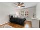 Comfortable bedroom with hardwood floors, ceiling fan, and a window with shutters at 259 Dartmoor Cir, Atlanta, GA 30328