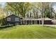 Charming home featuring a well-manicured lawn, gray siding and symmetrically placed windows at 259 Dartmoor Cir, Atlanta, GA 30328