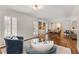 Cozy living room featuring hardwood floors, stylish decor, and large windows with plantation shutters at 259 Dartmoor Cir, Atlanta, GA 30328