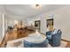 Open-concept living room with hardwood floors, modern furnishings, and an abundance of natural light at 259 Dartmoor Cir, Atlanta, GA 30328