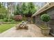 Charming patio with dining area, perfect for entertaining with lush landscaping and mature trees at 259 Dartmoor Cir, Atlanta, GA 30328