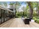 Spacious patio with outdoor seating area, lush landscaping, and mature trees at 259 Dartmoor Cir, Atlanta, GA 30328