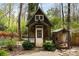 Rustic shed with cottage charm, set amidst a lush garden and mature trees at 259 Dartmoor Cir, Atlanta, GA 30328
