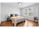 Bright bedroom with hardwood floors, two windows, and a comfortable bed with bright accents at 770 Waters Sw Dr, Atlanta, GA 30310