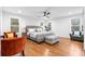 Bright bedroom features a ceiling fan, wood floors, two chairs and neutral decor at 770 Waters Sw Dr, Atlanta, GA 30310