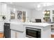 Bright kitchen island features a farmhouse sink and modern finishes with views to the dining room at 770 Waters Sw Dr, Atlanta, GA 30310