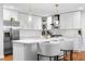 Modern kitchen with white cabinets, quartz countertops, stainless steel appliances, and an island with seating at 770 Waters Sw Dr, Atlanta, GA 30310