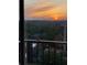 Balcony view showcasing a beautiful sunset over lush trees and city buildings at 195 14Th Ne St # 1507, Atlanta, GA 30309