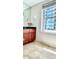 Well lit bathroom features a granite countertop, a wooden vanity, and a view of the city at 195 14Th Ne St # 1507, Atlanta, GA 30309