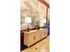 Foyer with neutral colored buffet, lamps, and a floral arrangement against a mural background at 195 14Th Ne St # 1507, Atlanta, GA 30309