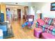 Inviting living room featuring hardwood floors, colorful sofa, and a vintage leather chair at 195 14Th Ne St # 1507, Atlanta, GA 30309
